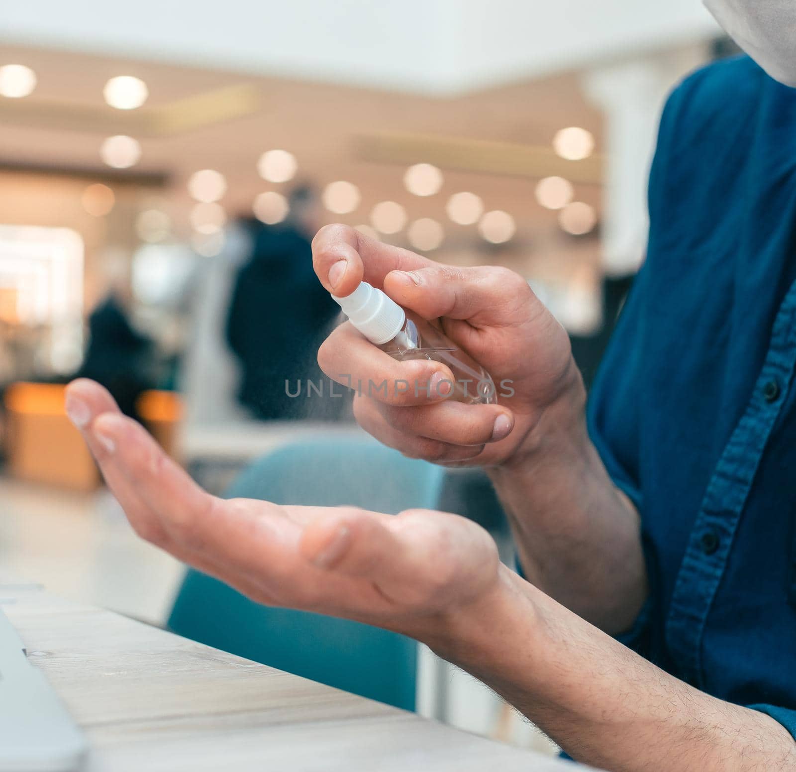 spray with antiseptic in the hands of a young man by SmartPhotoLab