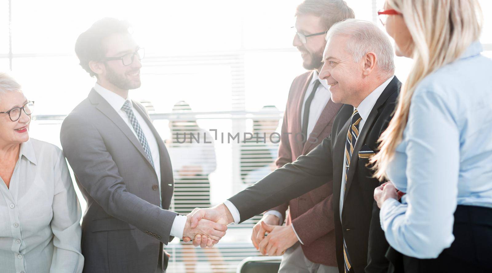 business partners shaking hands before starting negotiations. by SmartPhotoLab