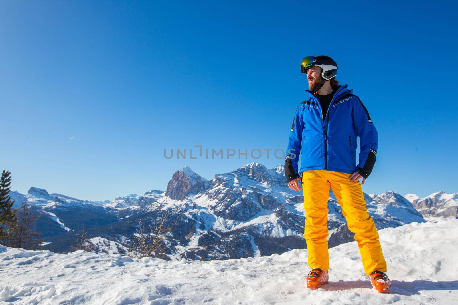 Happy skier on slope at Cortina by destillat