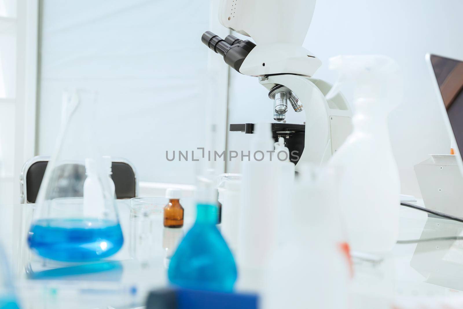 microscope on a table in a modern laboratory. by SmartPhotoLab