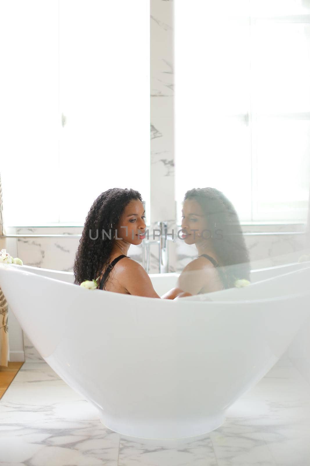 Black girl taking bath and relaxing, reflection in glass. by sisterspro