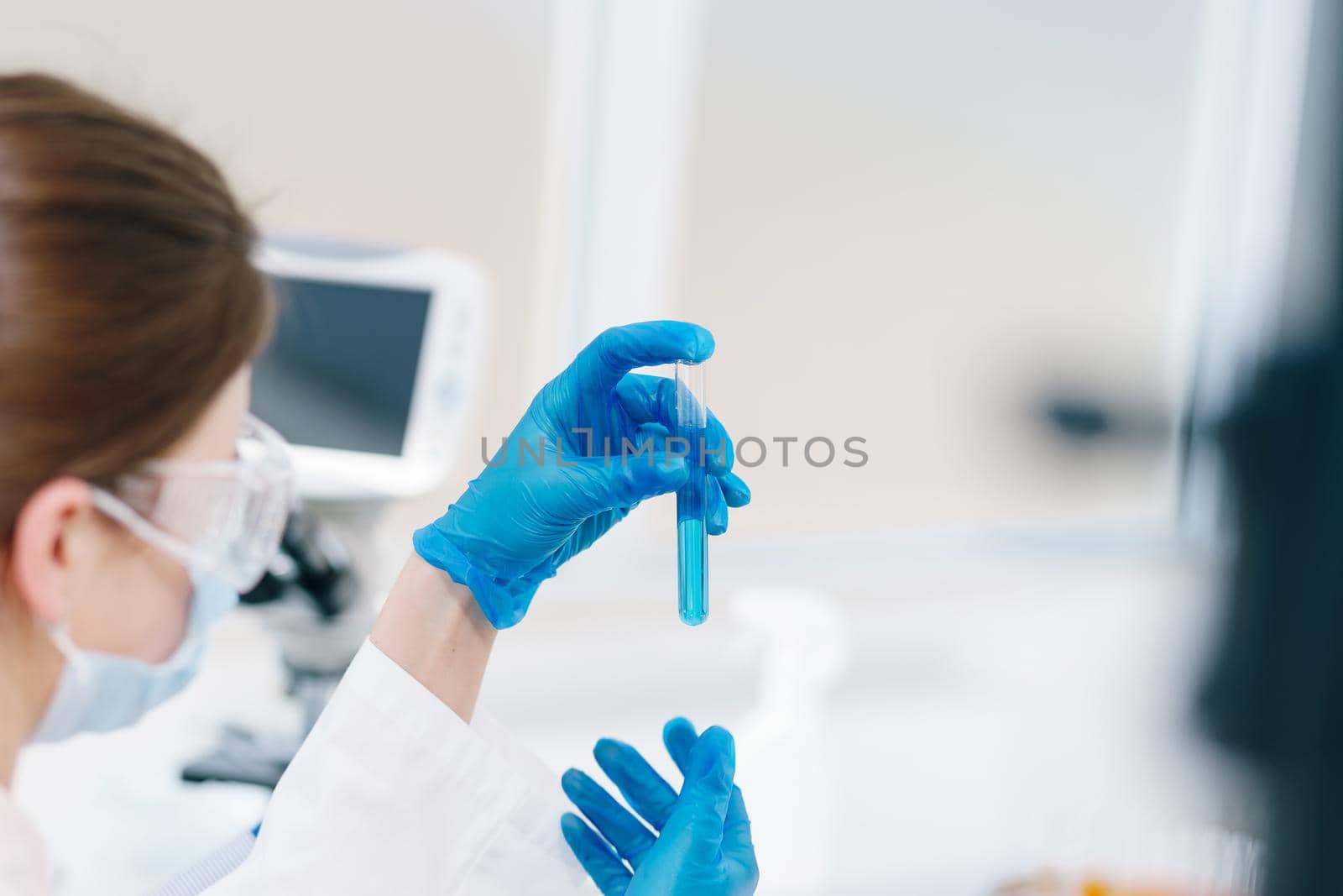 close up. laboratory workers with test tubes sitting at the laboratory table. by SmartPhotoLab