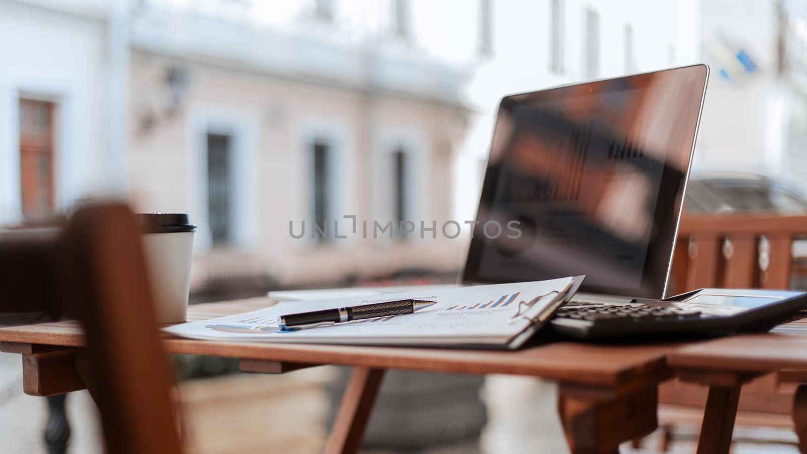 close up. takeaway coffee and financial schedule on the cafe terrace. by SmartPhotoLab