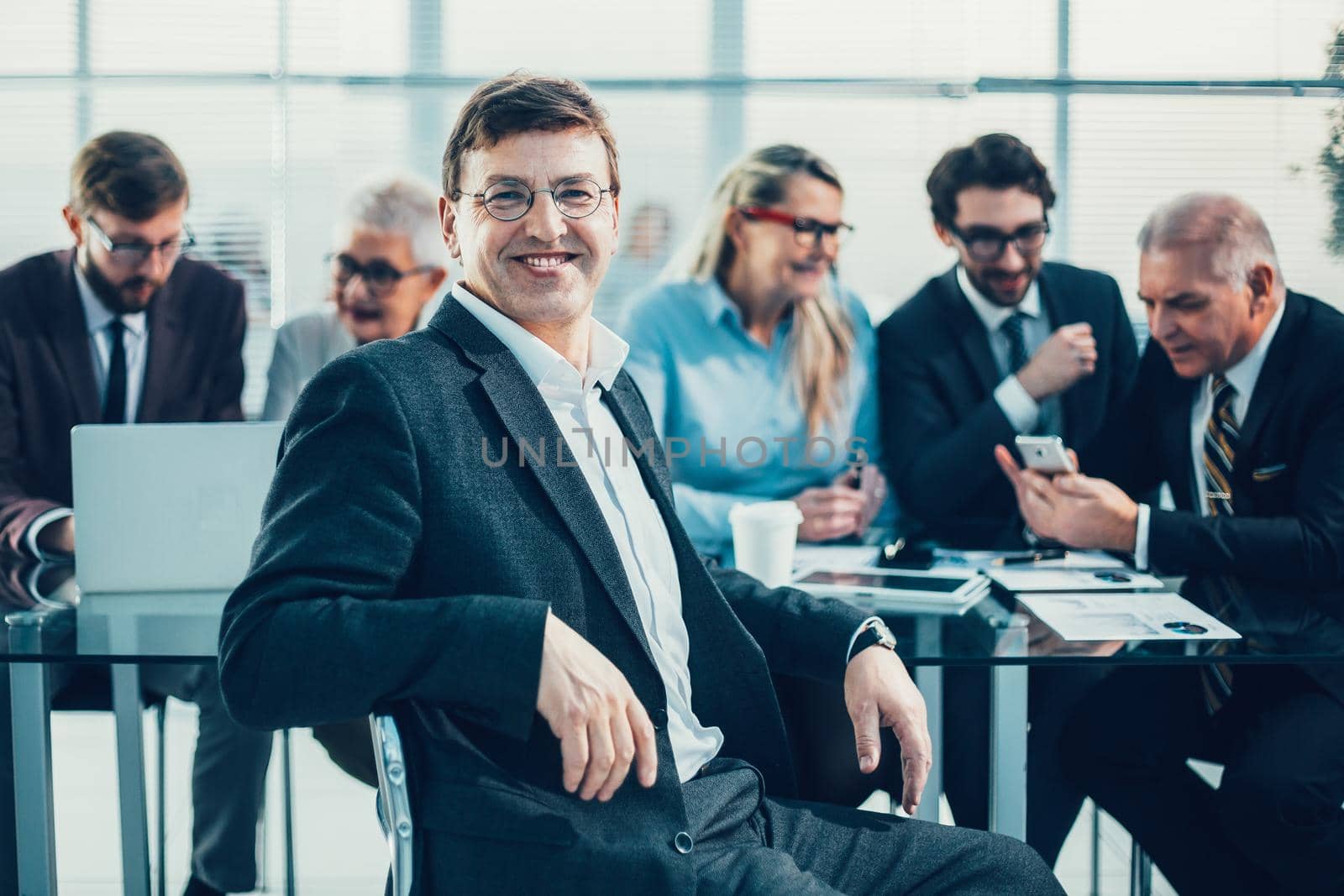 close up. confident business man sitting in front of an office Desk