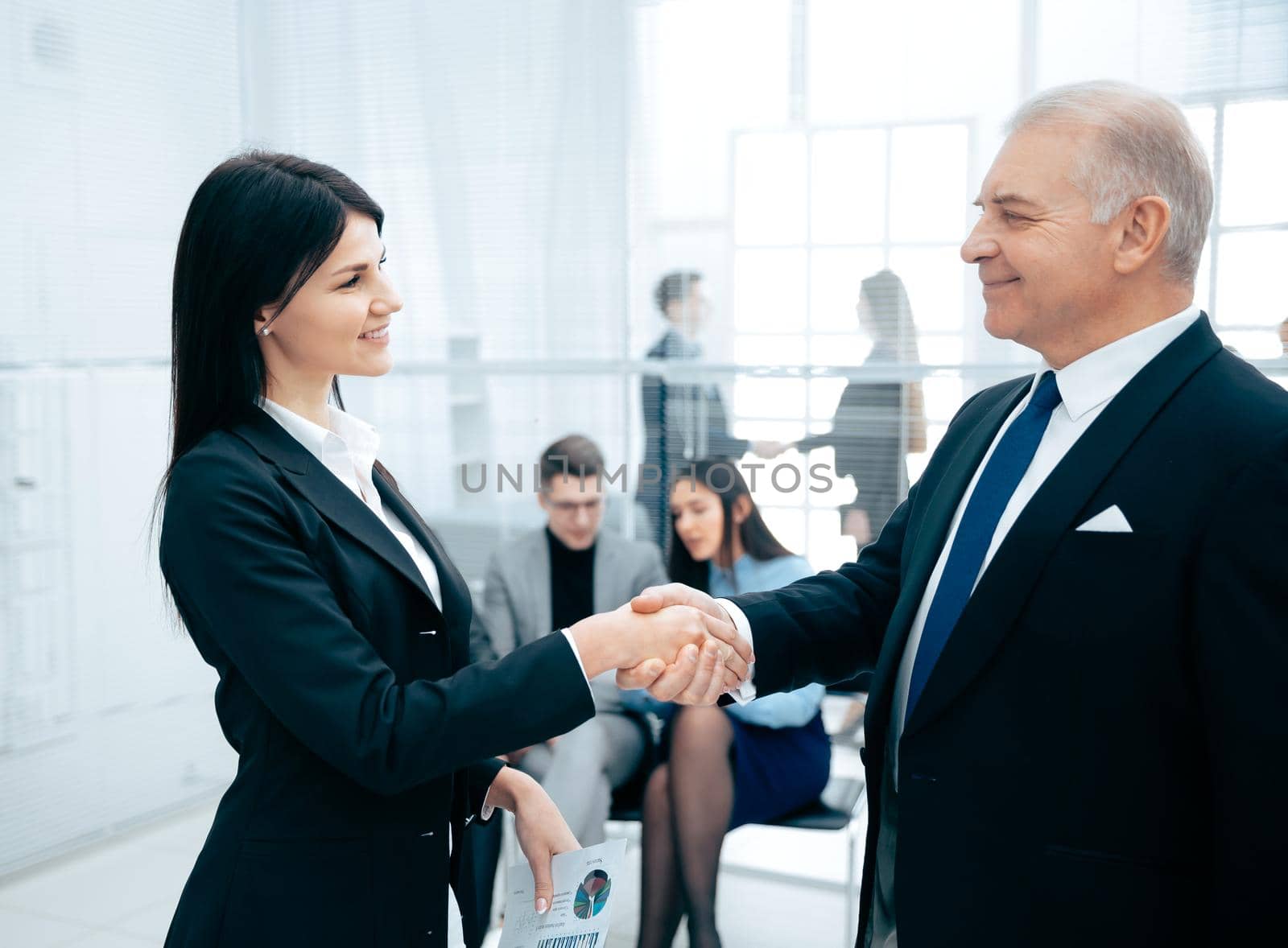 business partners greeting each other with a handshake by SmartPhotoLab