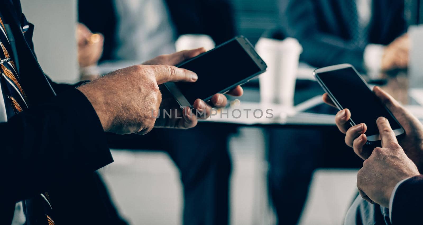 close up. business people using their smartphones in the office. people and technology