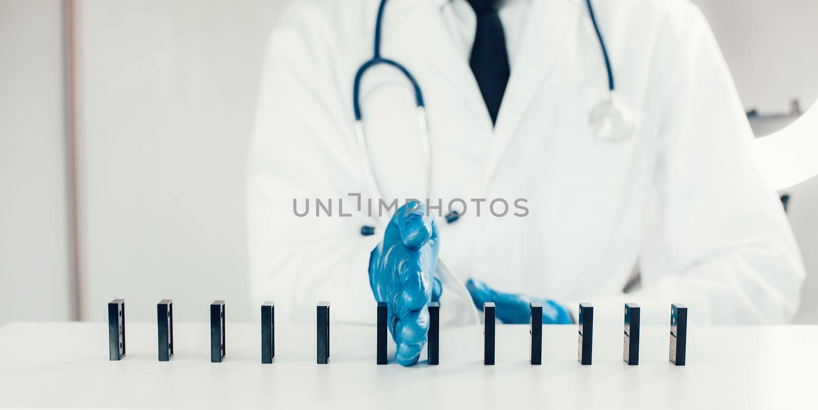 close up. doctor using dominoes to show a safe distance . by SmartPhotoLab