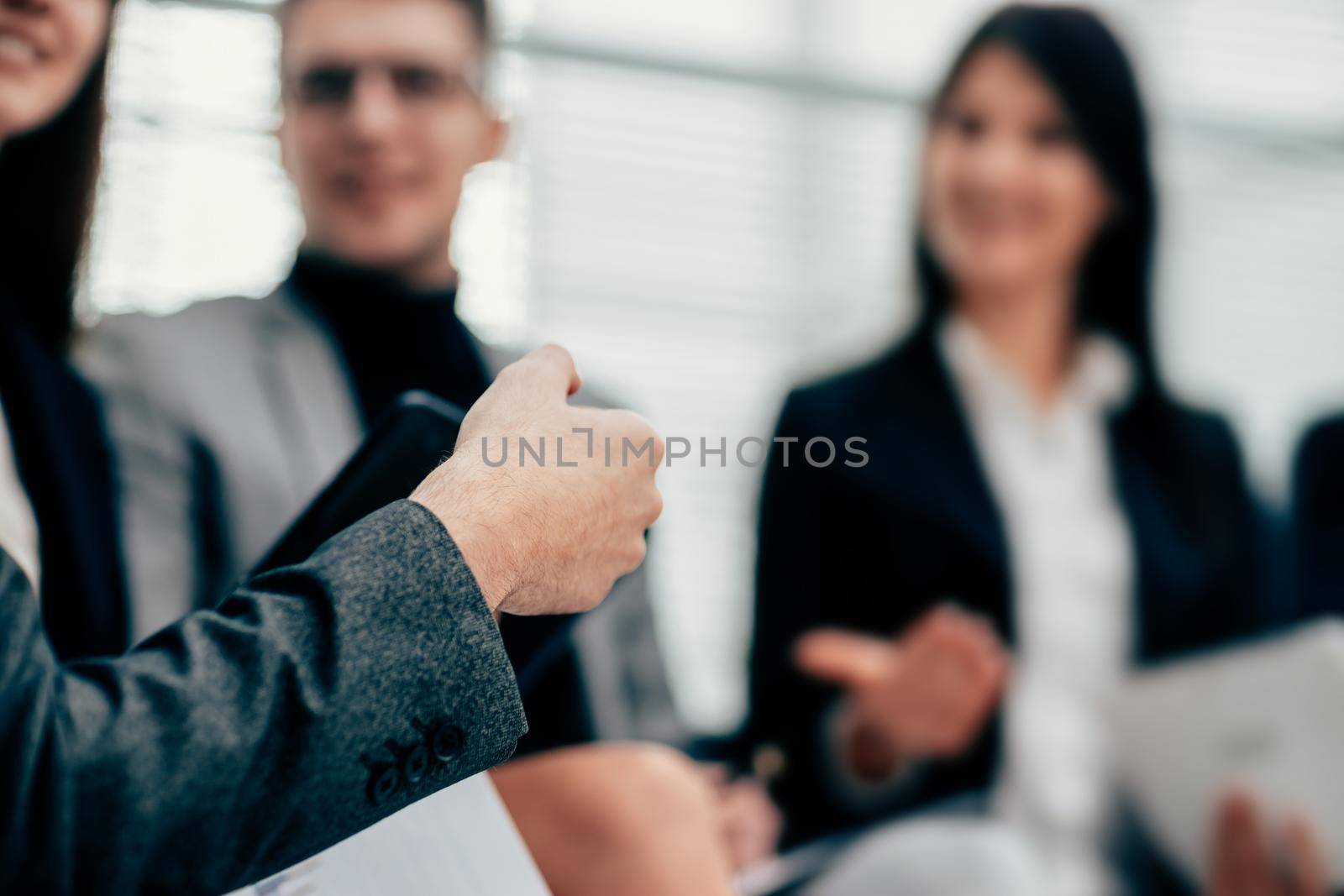 blurry image of a business team discussing new ideas by SmartPhotoLab