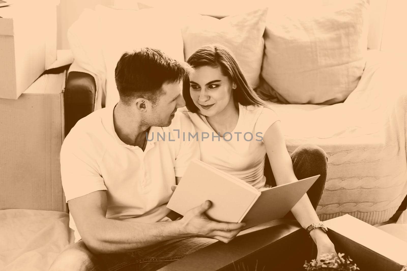 young couple looking for a family photo in a new apartment. by SmartPhotoLab