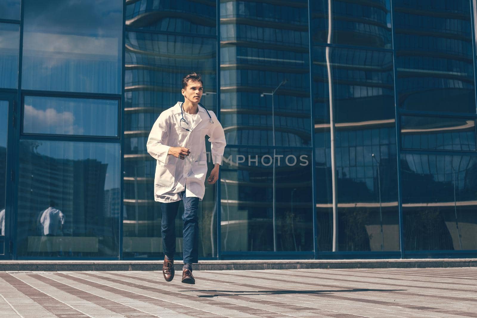 in full growth. a concerned doctor runs to help. by SmartPhotoLab