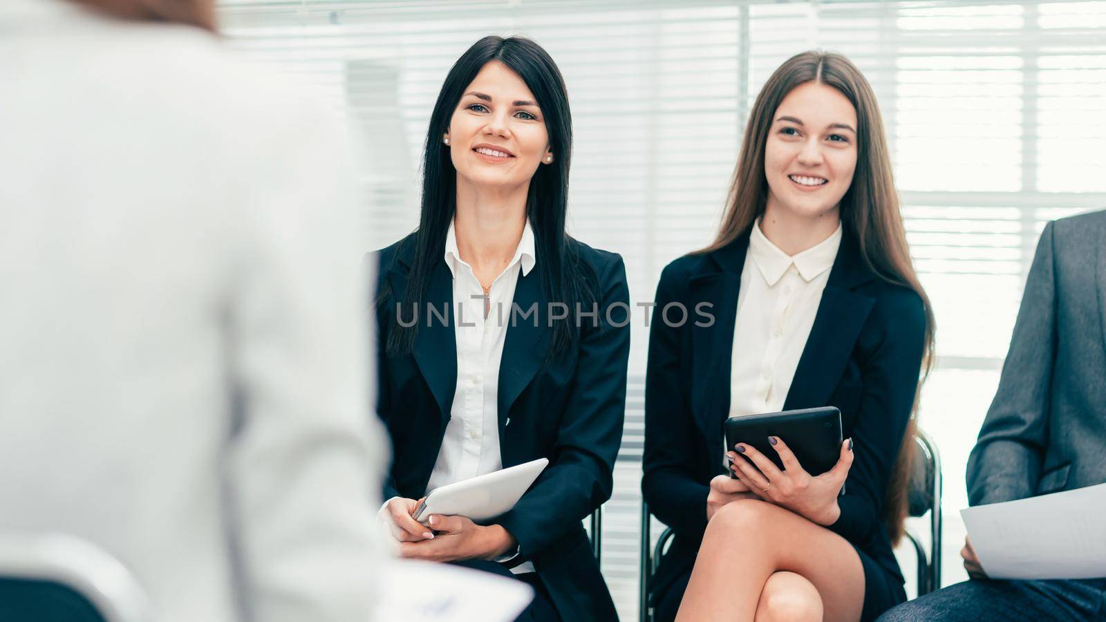 close up. employees asking questions at a work meeting by SmartPhotoLab