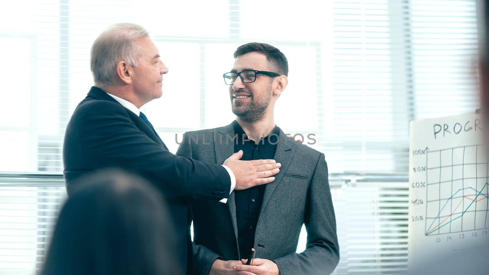 project Manager congratulating the best employee at a meeting with the working group. photo with copy-space