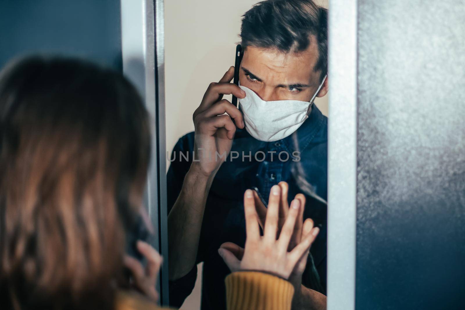 close up. a young man and a woman are looking at each other anxiously through the glass. photo with a copy-space