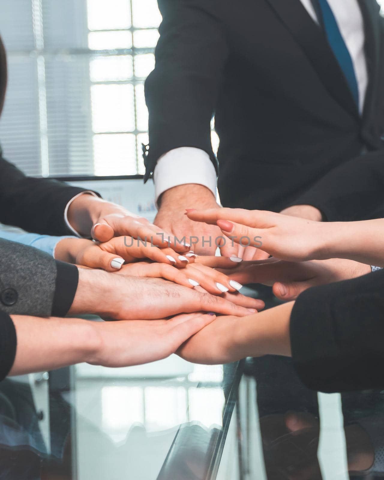 close up. business team showing their unity while sitting at the office table