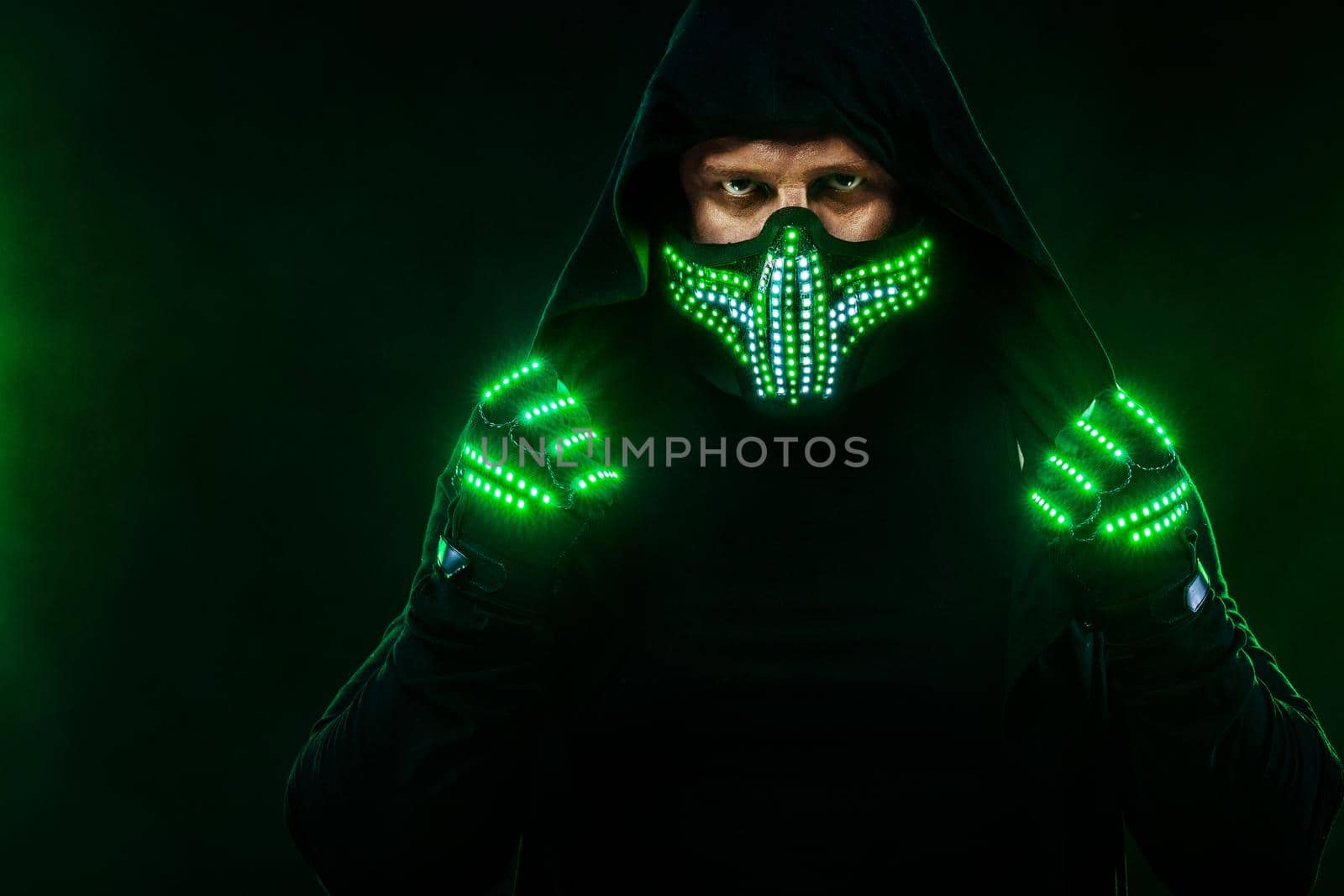 Mysterious man in black wear, neon mask and gloves. Character pastor or wizard in robe from the future. Assassin with strong face expression. Fantasy book or computer game cover concept. by MikeOrlov