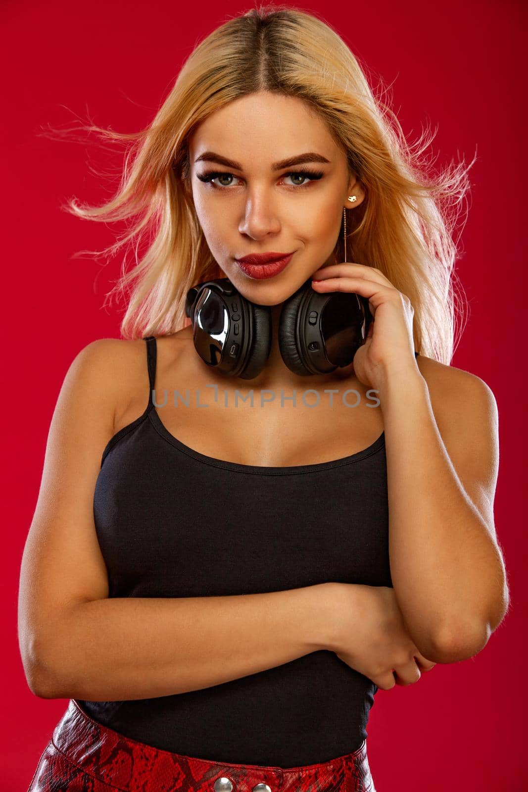 Club poster for night party with young sporty and beautiful woman DJ with headphones isolated on red background. by MikeOrlov