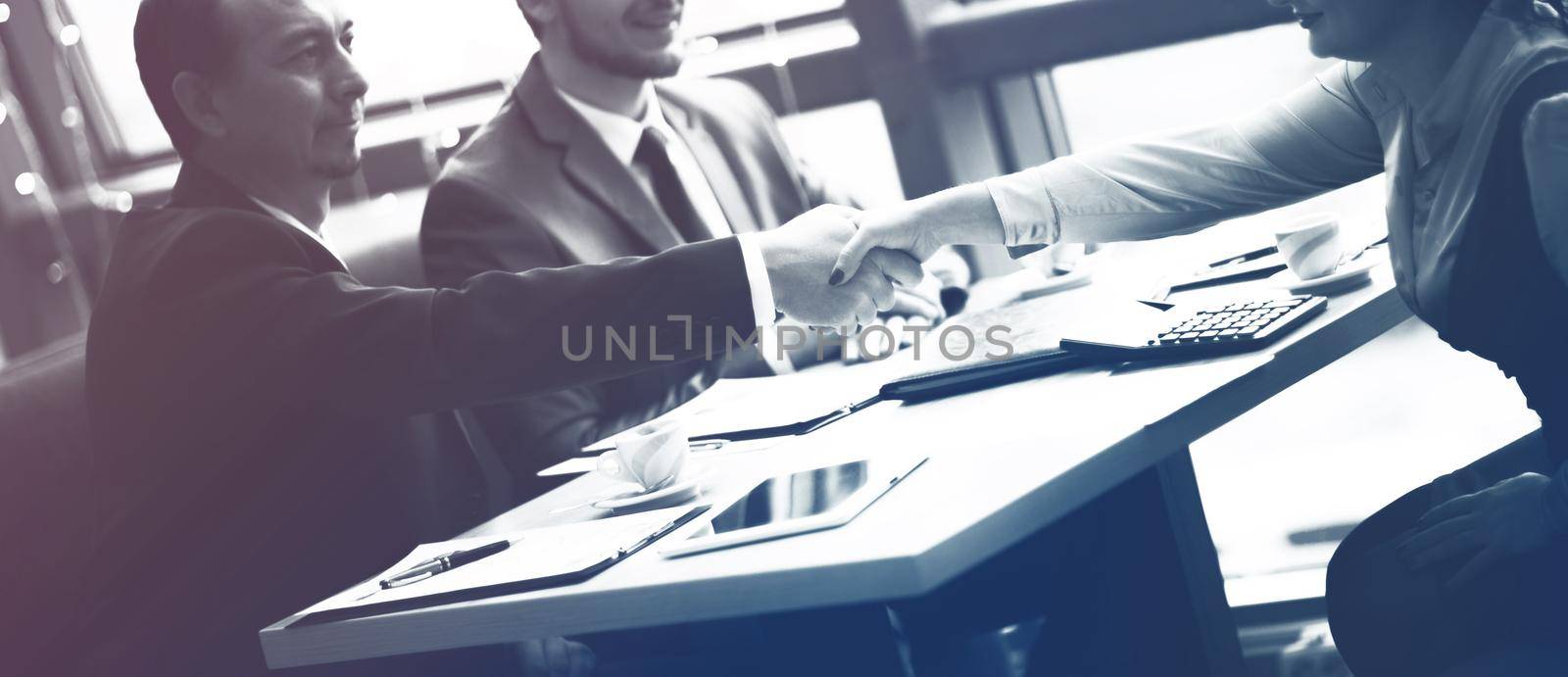Business handshake. Handshake of two business men closing a deal at the office by SmartPhotoLab