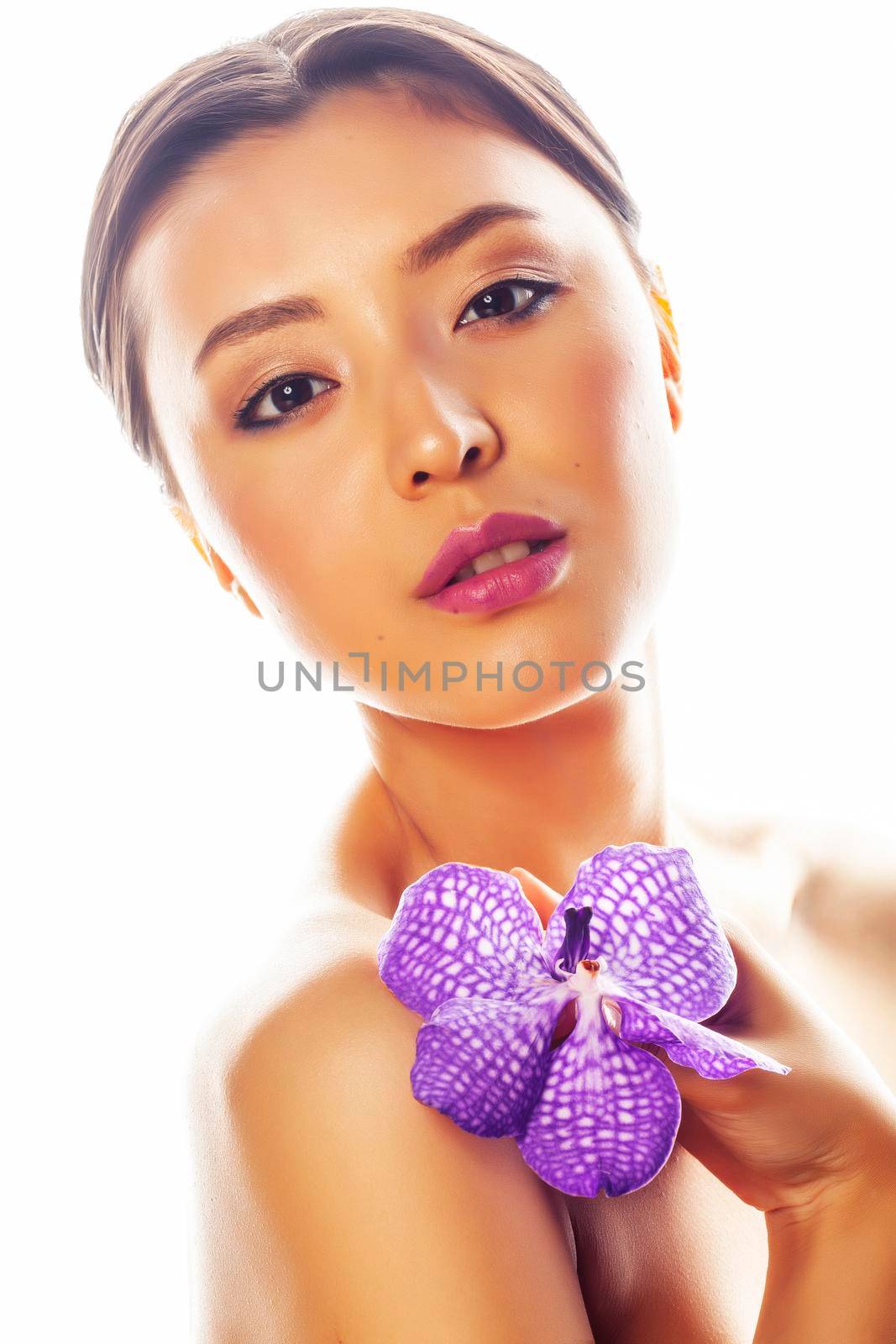 young pretty asian woman with flower purple orchid isolated on white background, spa people concept by JordanJ