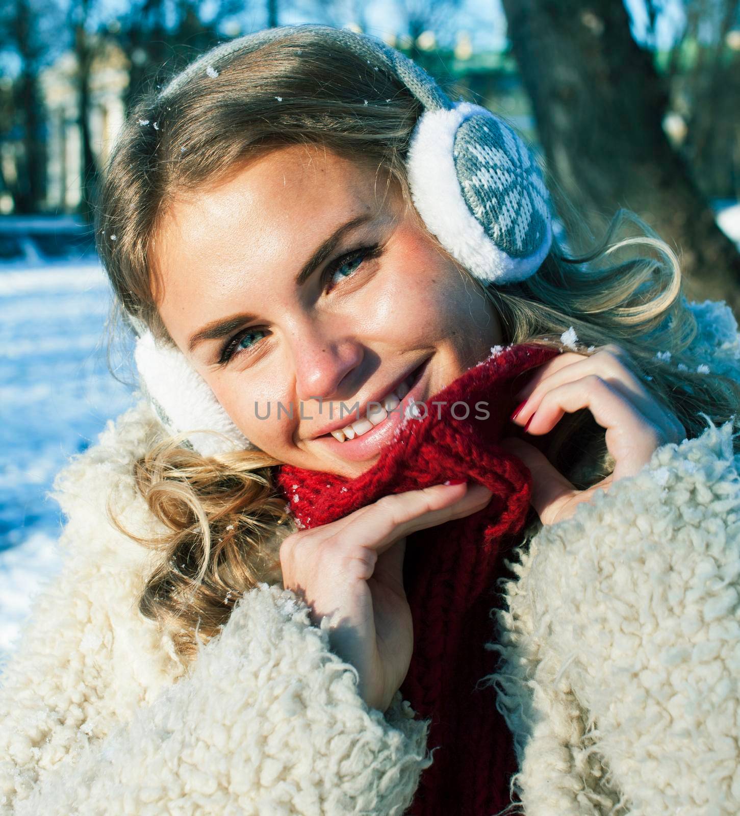 young pretty teenage hipster girl outdoor in winter snow park having fun drinking coffee, warming up happy smiling, lifestyle people concept close up