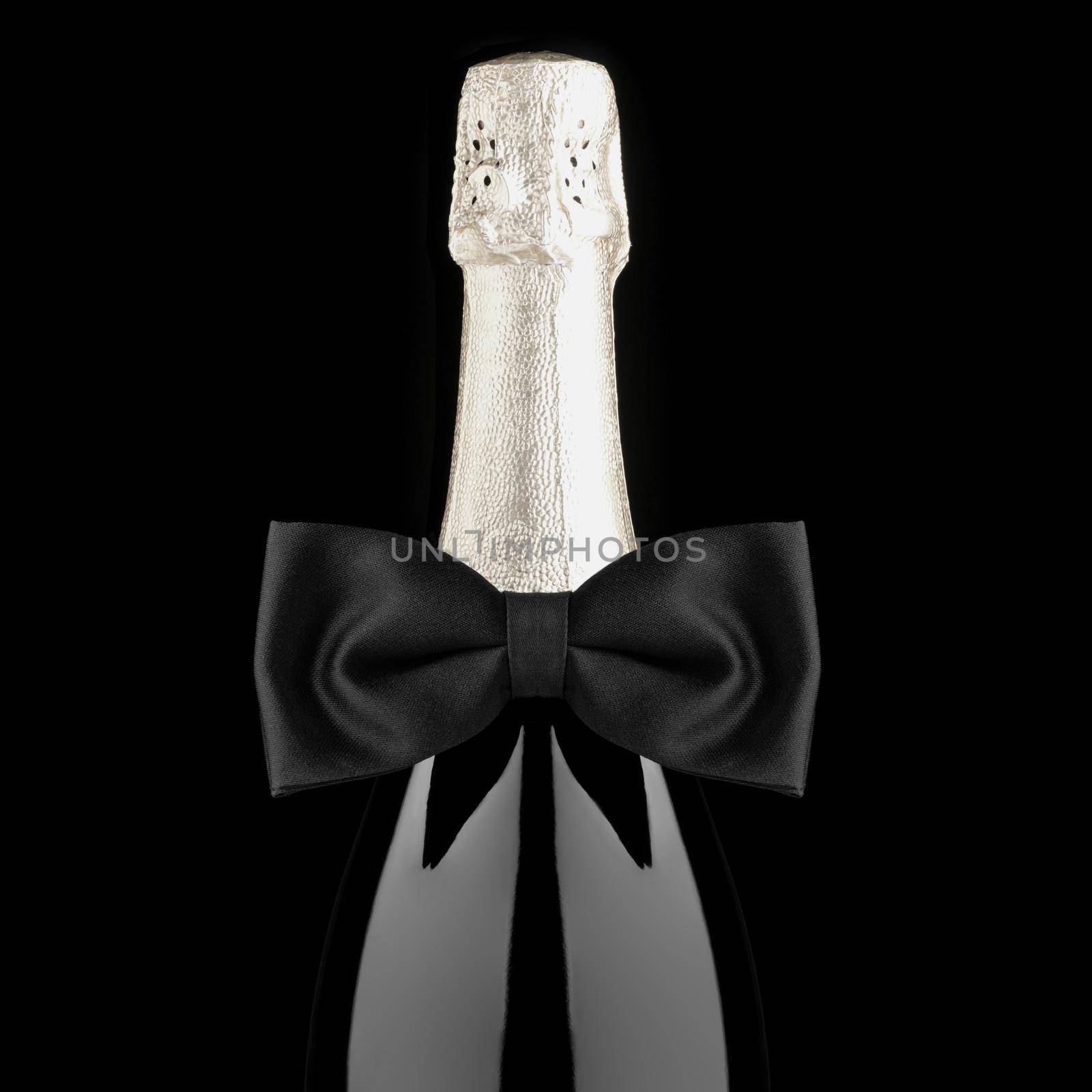 Closeup of a Champagne Bottle with Black Bow Tie isolated on Black Background square format desaturated