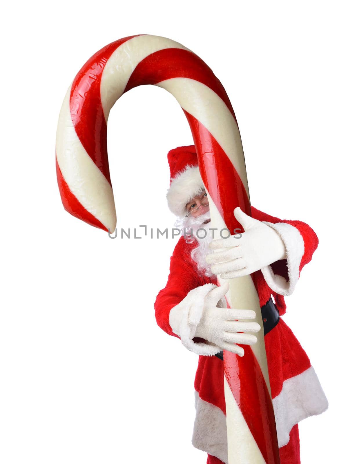 Man is traditional Santa Claus costume with his arms wrapped around a huge Candy Cane.
