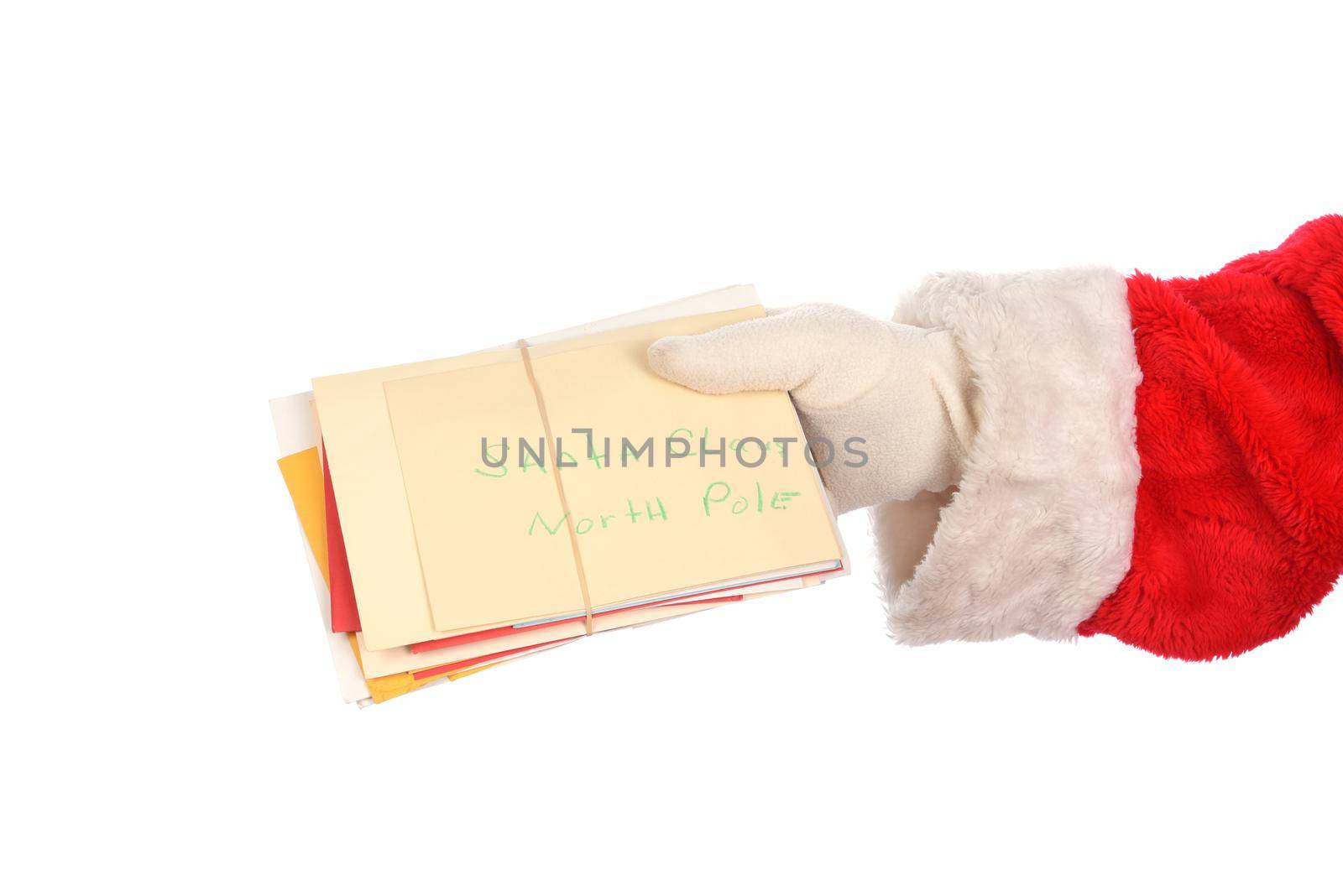 Santa Claus holding a bunch of Christmas letters from children. Hand only isolated on white. by sCukrov