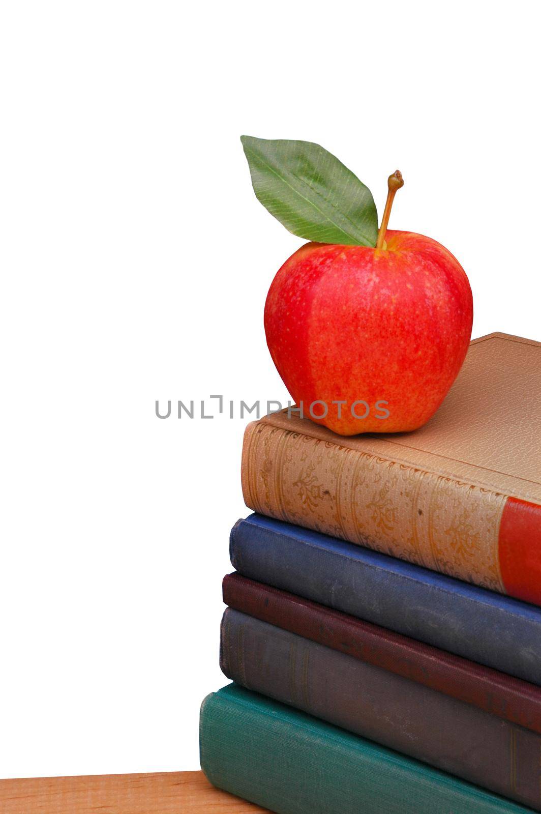 Red Apple with Green Leaf on Stack of Old Books isolated on white