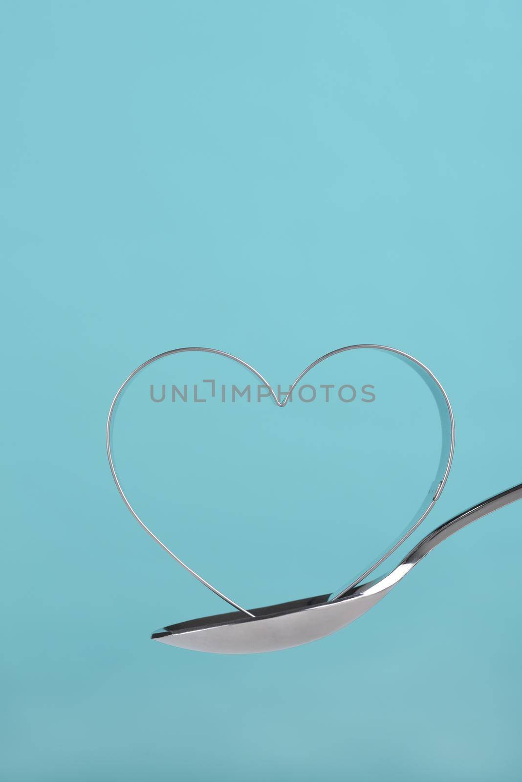 Heart shaped cookie cutter balanced on a spoon  by sCukrov