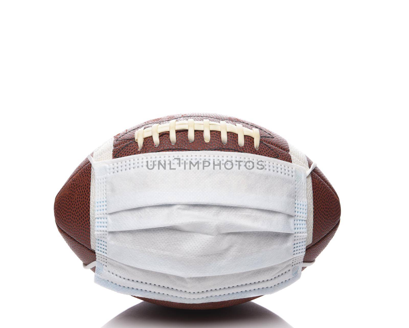 Sports and Covid-19 Concept.  An american Foortball with a surgical mask. 