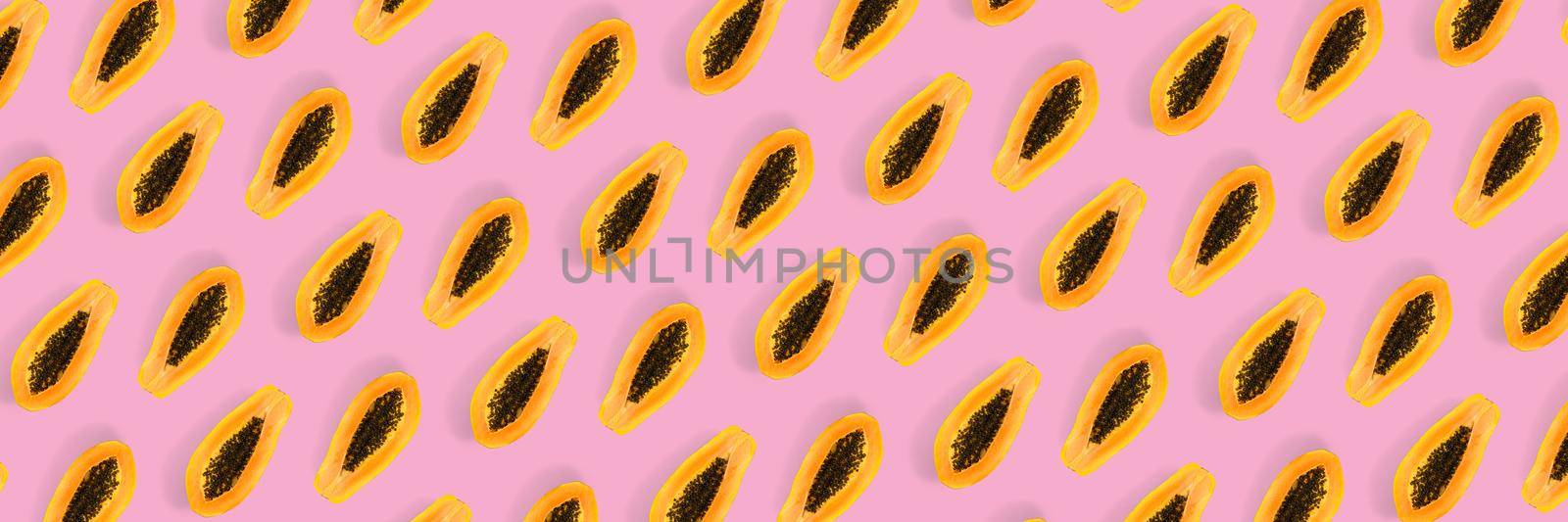 Fresh ripe papaya background on pink backdrop. Tropical abstract background. Top view. modern by PhotoTime