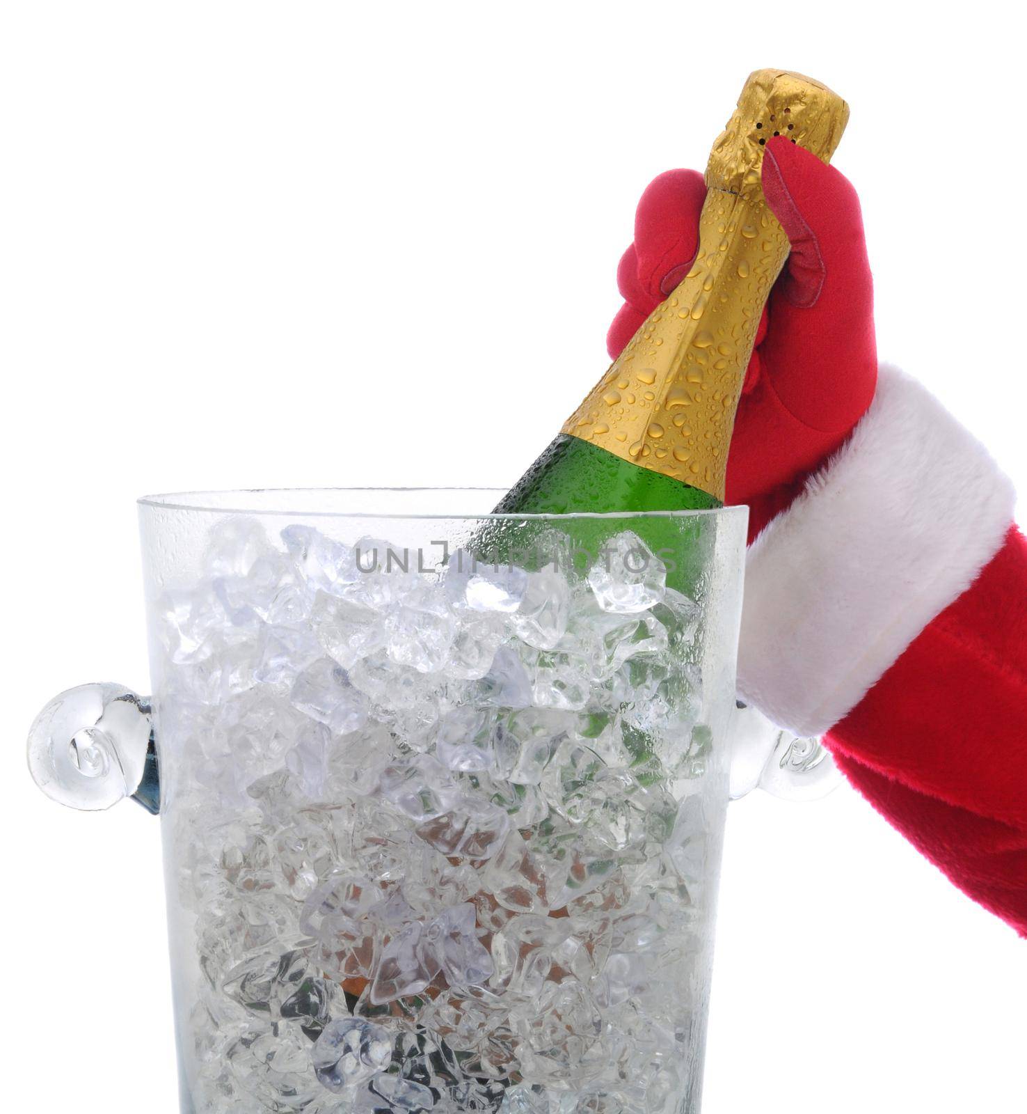 Santa Claus hand taking a champagne bottle in a cyrstal ice bucket isolated on white.