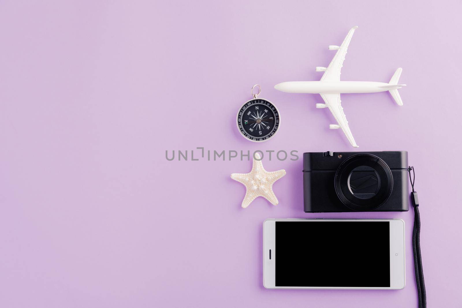 model plane, airplane, starfish, alarm clock, compass and smartphone blank screen by Sorapop