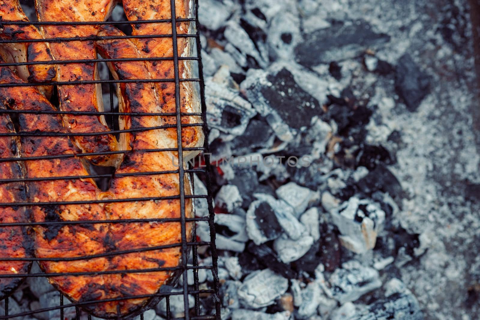 cooking fish outdoors barbecue close-up charcoal meal. High quality photo