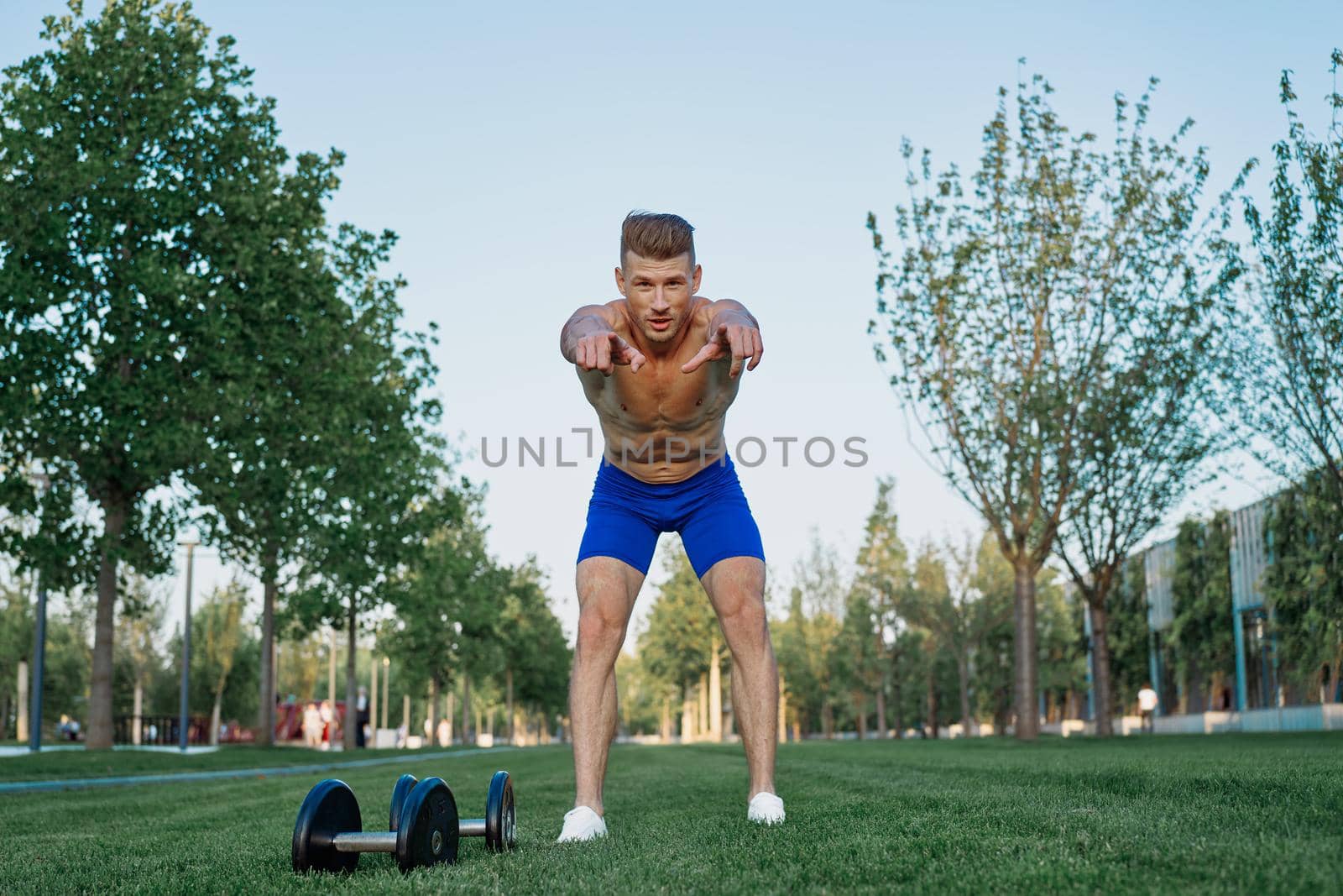 sporty man in park exercise crossfit workout by Vichizh