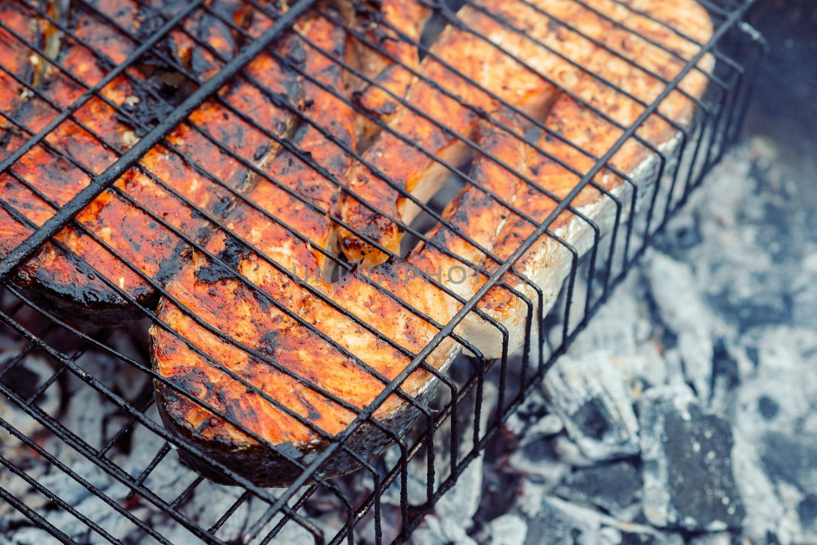 cooking fish outdoors barbecue close-up charcoal meal. High quality photo