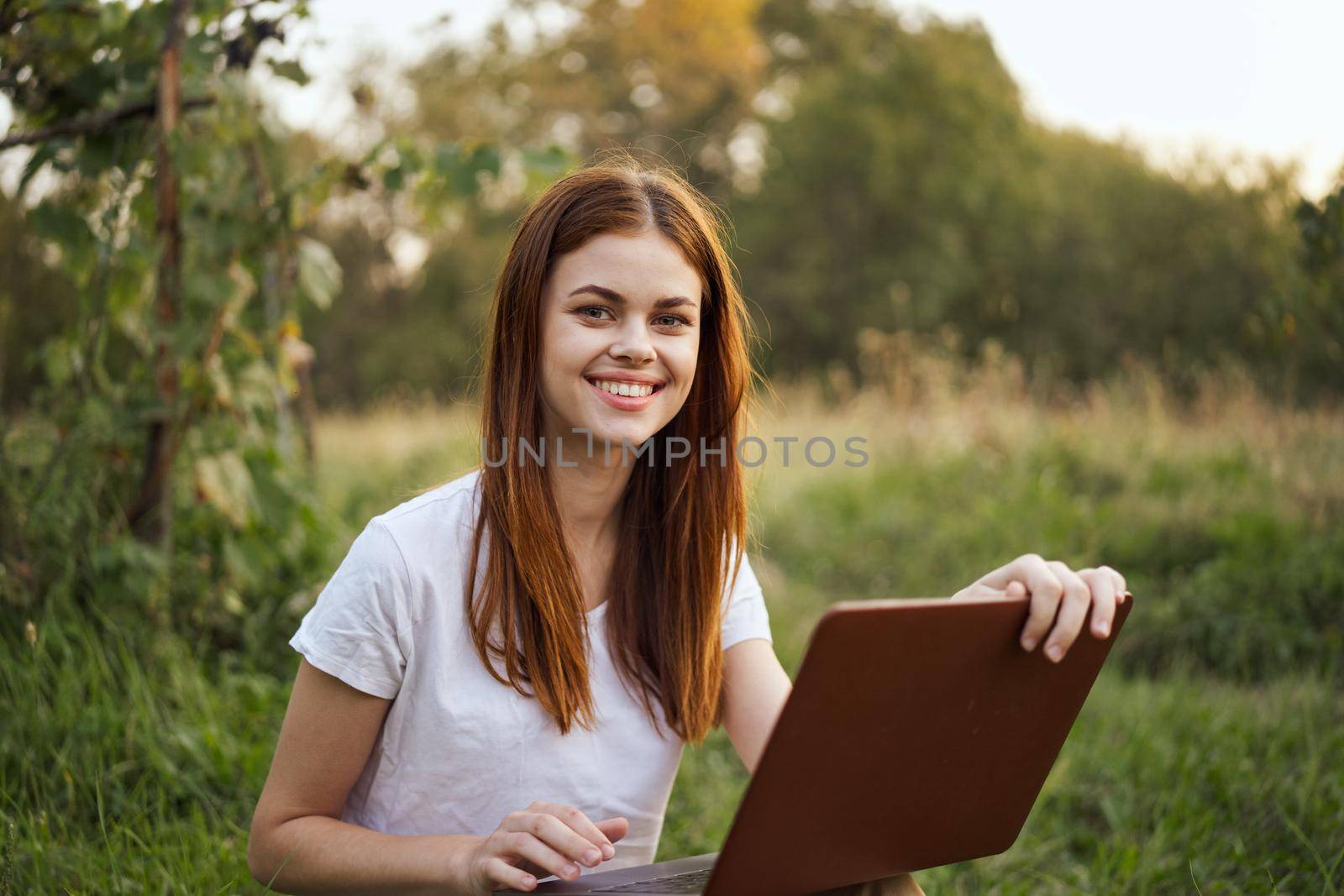 cheerful woman outdoors laptops communication internet. High quality photo