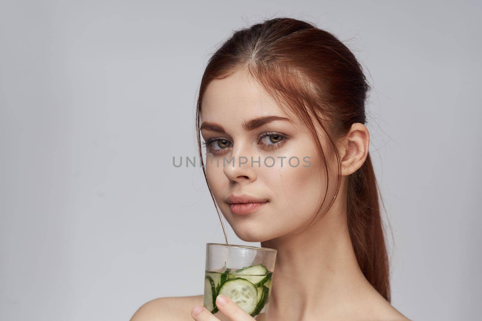 woman with cucumber drink health vitamins close-up by Vichizh