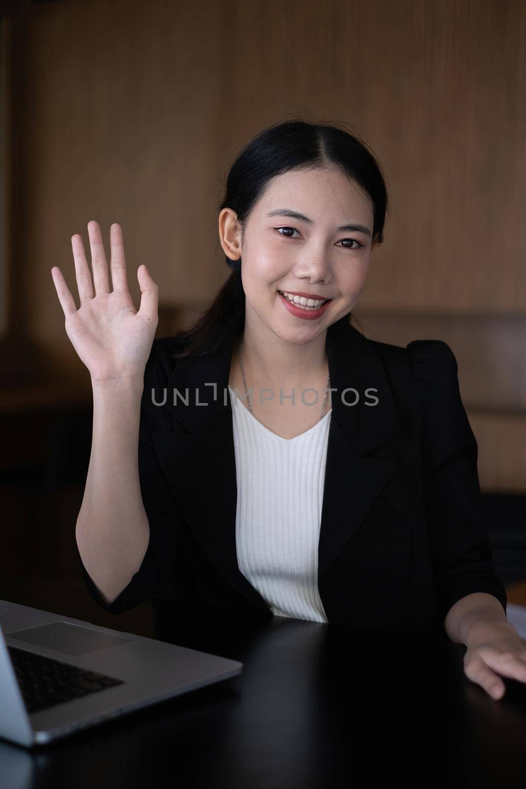 Happy Business woman have hand wave with her partner at morning in office. account finance tax concept.