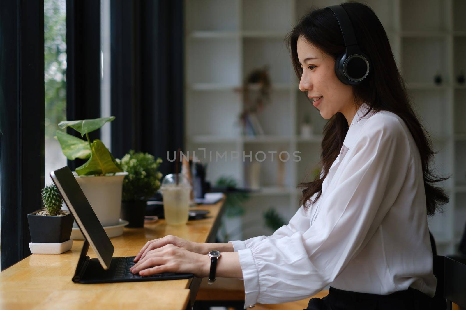 Businesswoman in having a video call on laptop while discussion with business partner during work from home. Support concept. by itchaznong