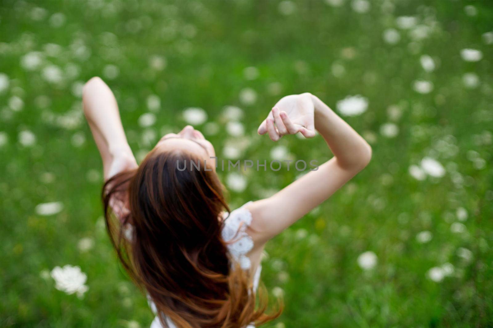 Woman in white dress in a field of flowers walk freedom by Vichizh