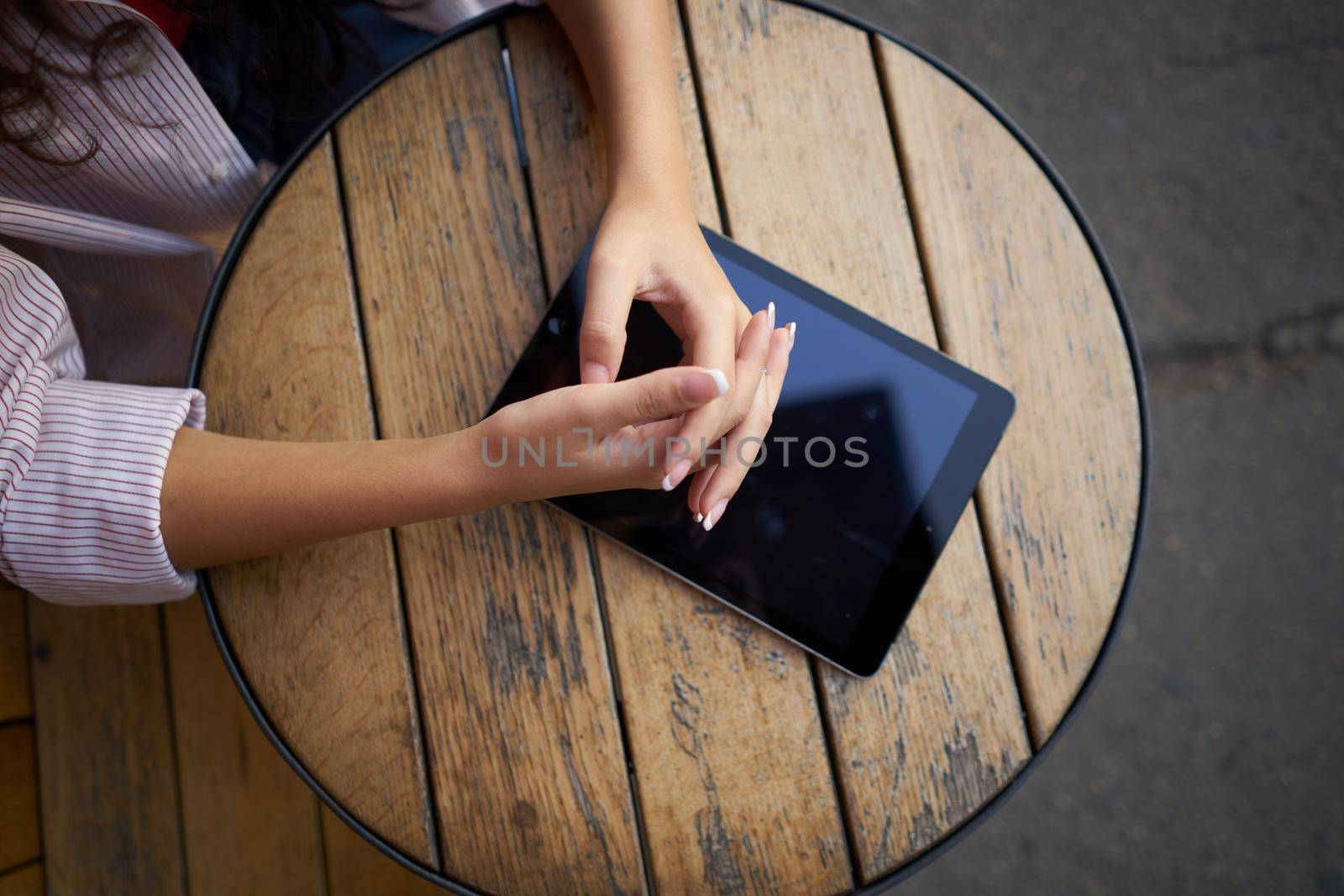 wooden table outdoor cafe tablet work lifestyle. High quality photo
