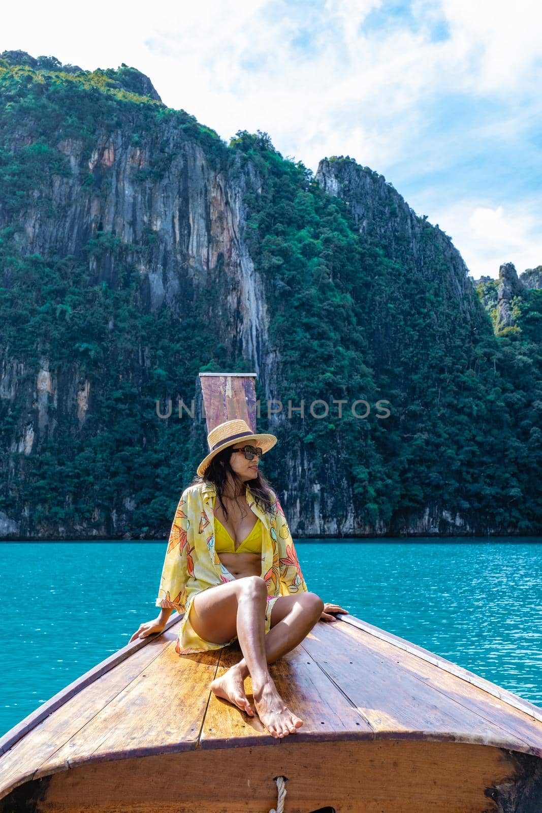 Maya Bay Koh Phi Phi Thailand, Turquoise clear water Thailand Koh Pi Pi, Scenic aerial view of Koh Phi Phi Island in Thailand. Asian woman mid age with hat in longtail boat