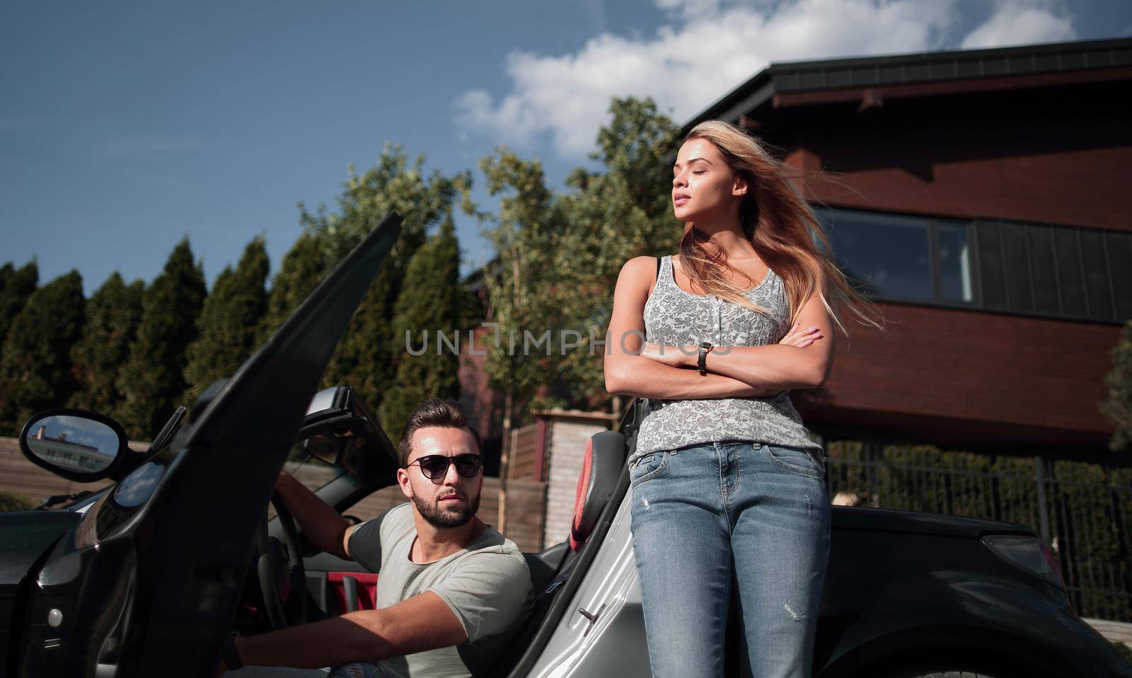 young couple standing near luxury car.the concept of a successful lifestyle