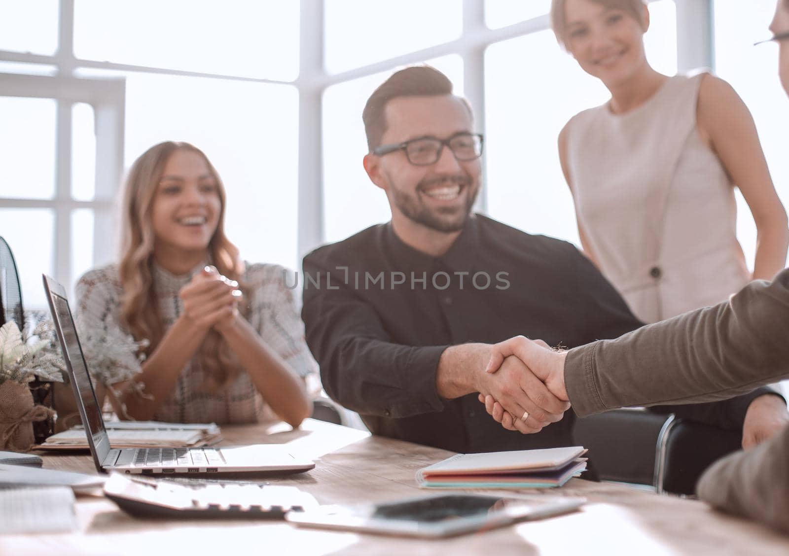 happy business colleagues shaking hands with each other. success concept