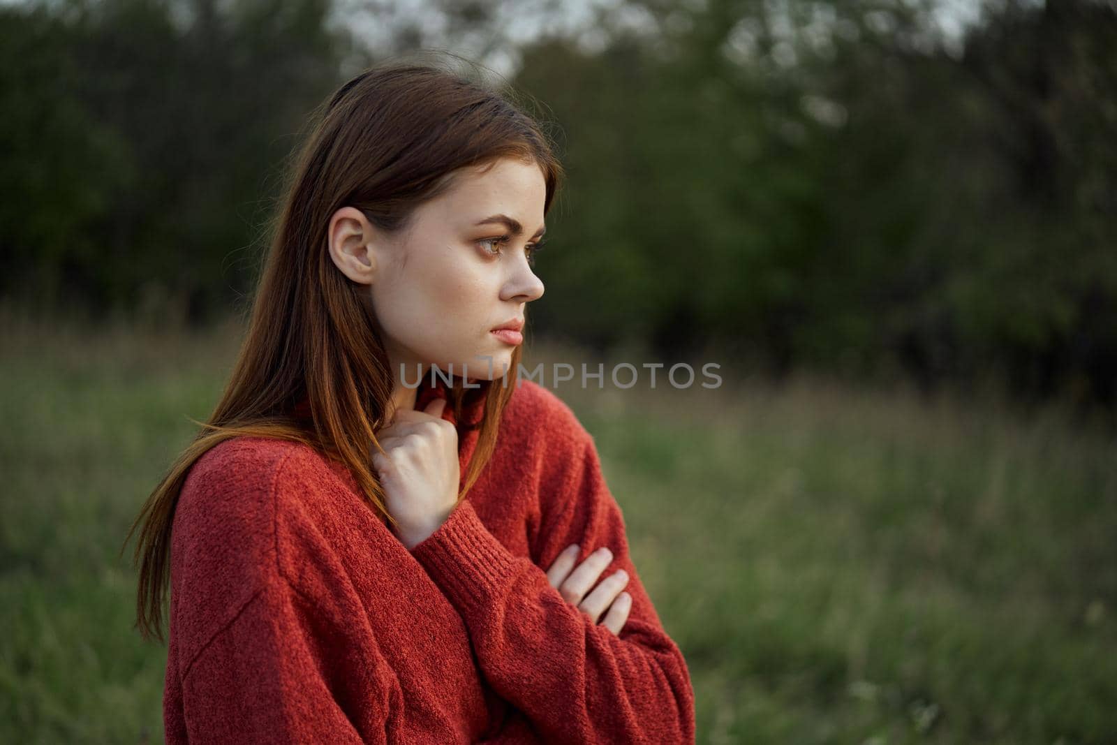 woman in a red sweater outdoors in a field walk by Vichizh