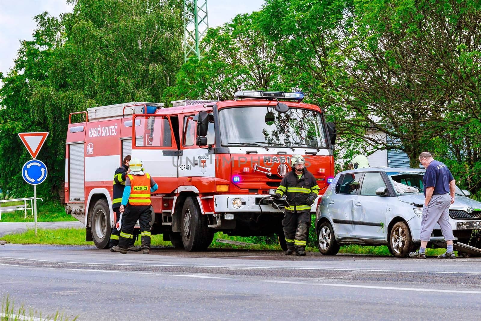 Skutech, Czech Republic, 26 June 2020: Car accident, the car drove off the road. Rescuers and police officers provide assistance. Police car and fire engine.