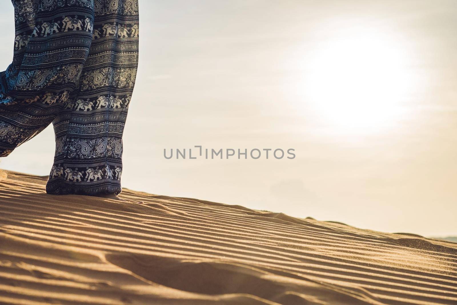 young woman in rad sandy desert at sunset or dawn