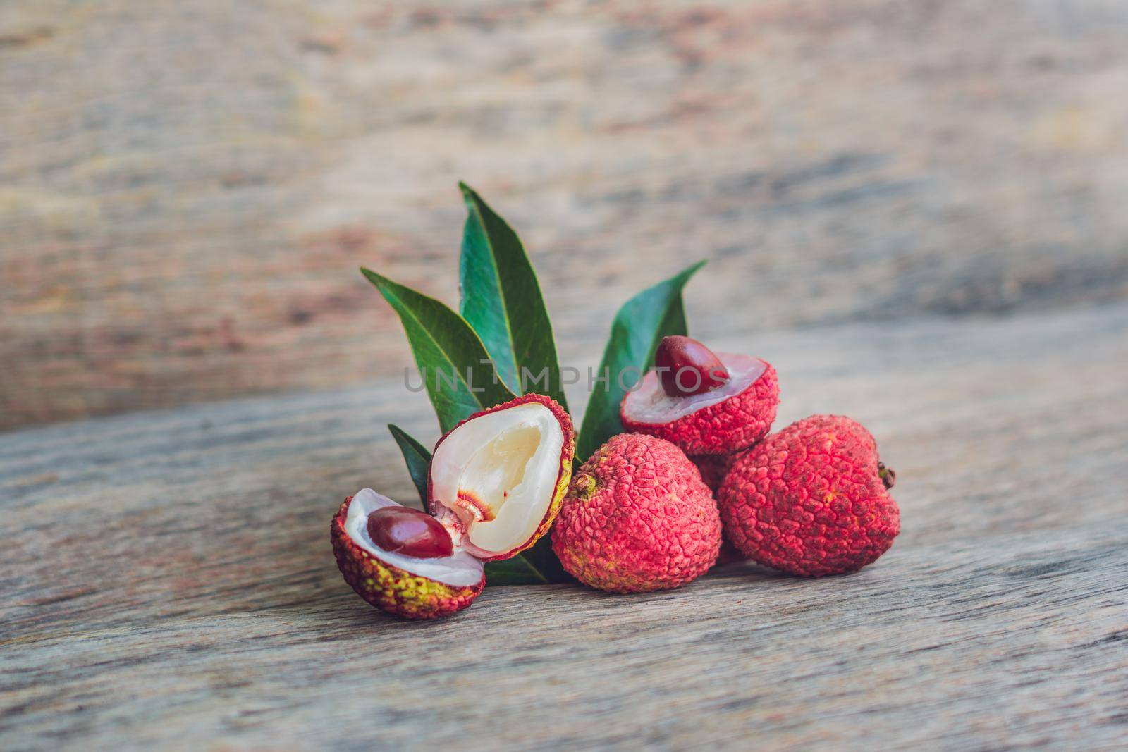 Fresh litchi fruit on an old wooden background.