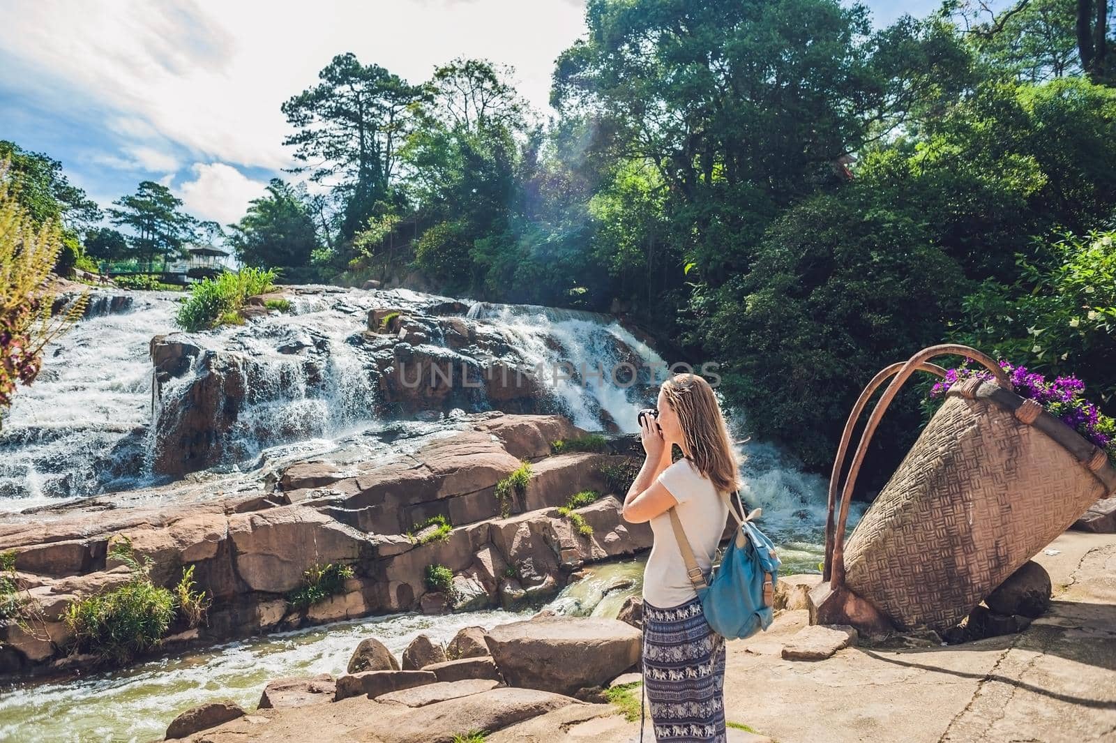 Young woman on the background of Beautiful Camly waterfall In Da Lat city by galitskaya