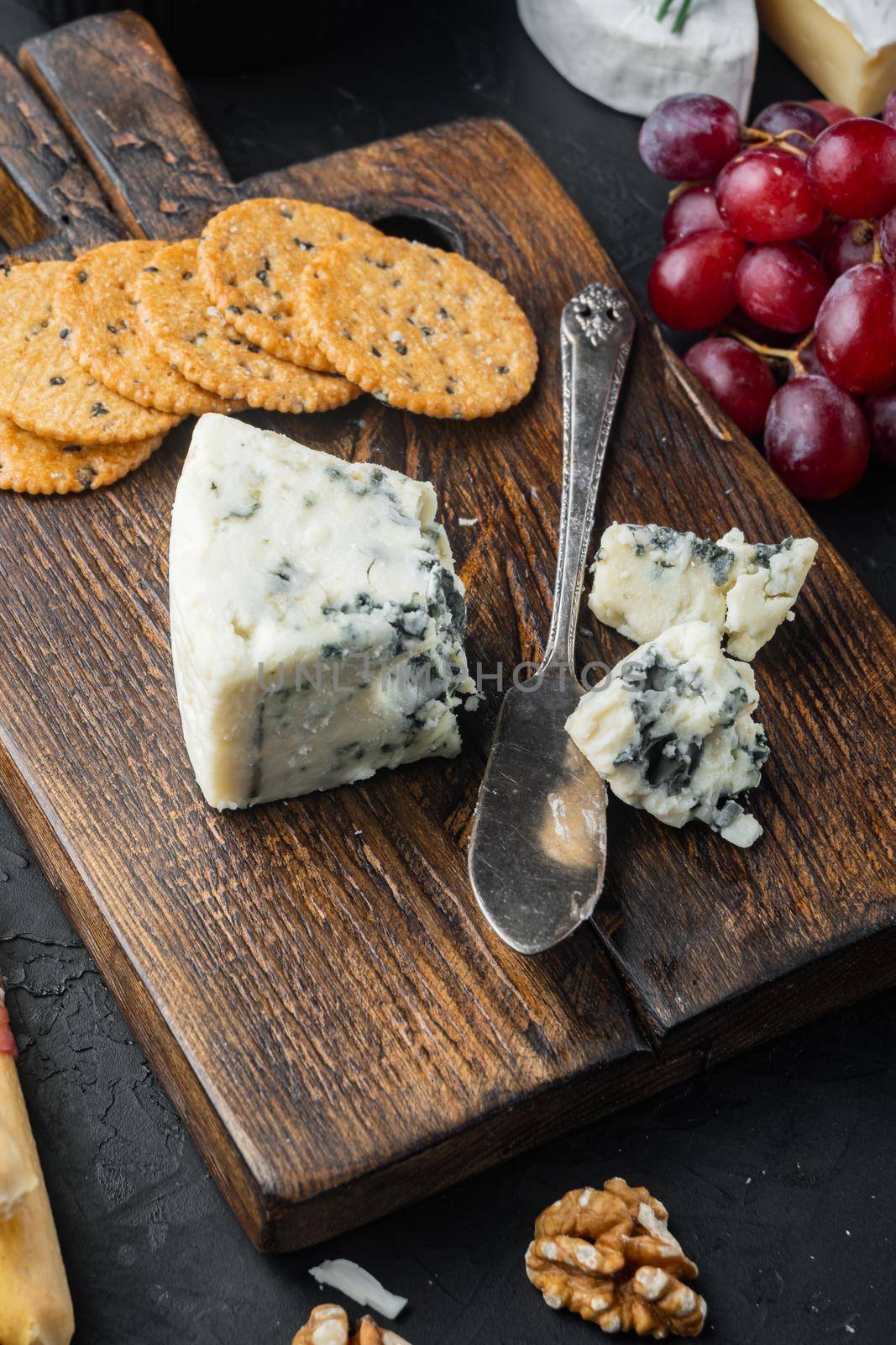 Wedges of soft blue cheese, on black background